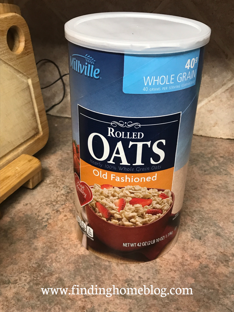 A canister of old-fashioned oats on a kitchen counter