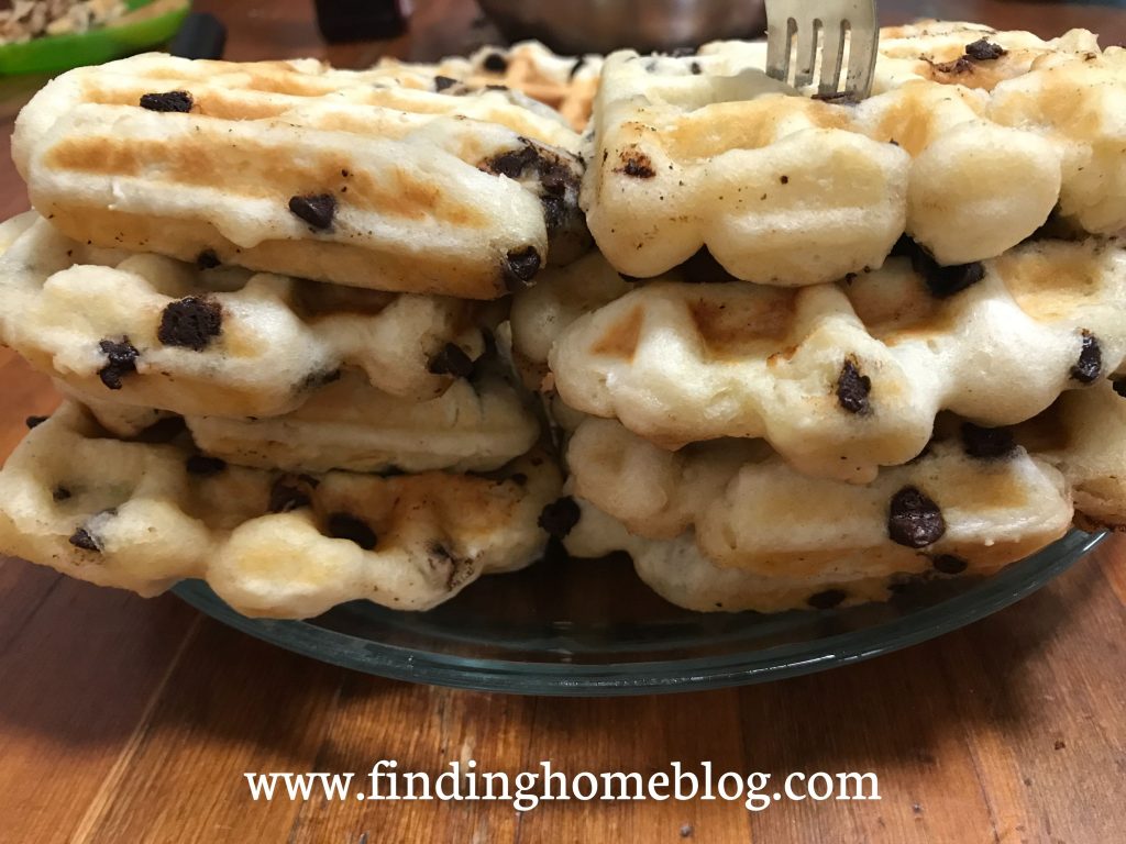 Two stacks of chocolate chip waffles with a fork stuck in the top