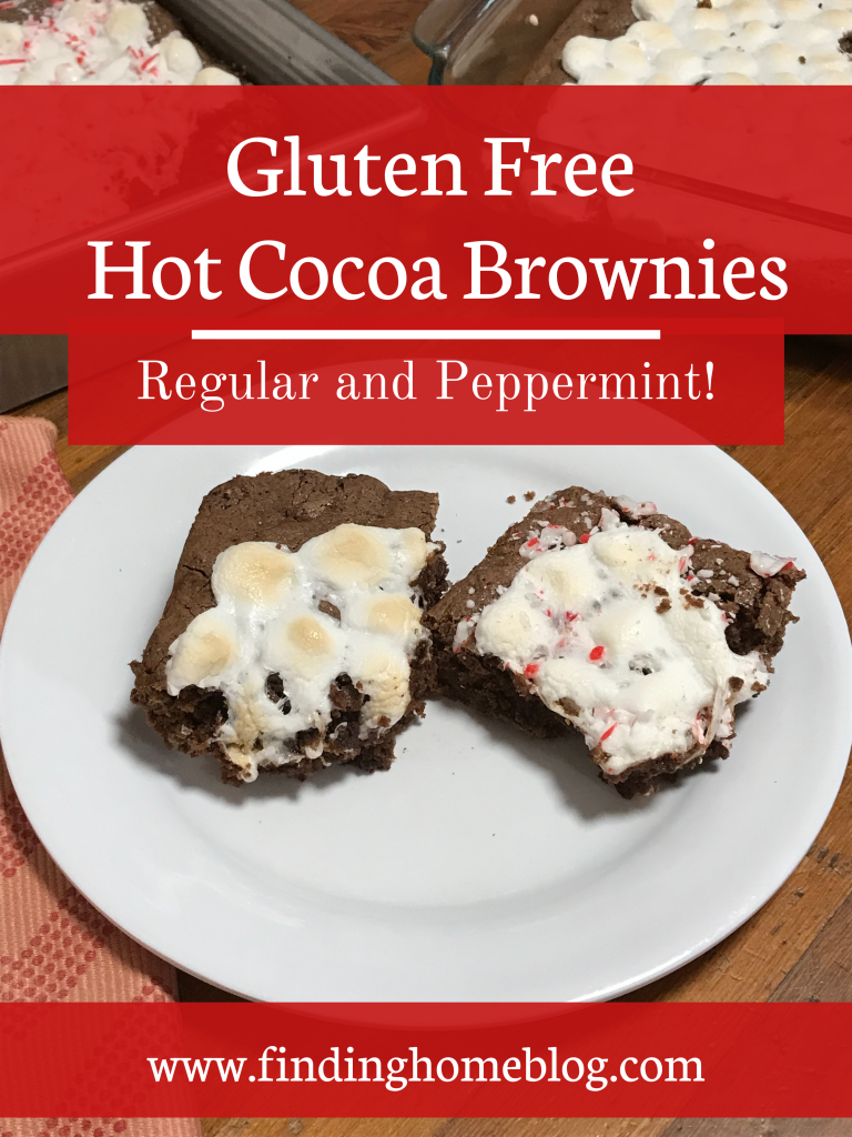 Two brownies topped with marshmallows on a plate in the foreground, with two pans of brownies in the background. A red banner that states "Gluten Free Hot Cocoa Brownies, Regular and Peppermint"