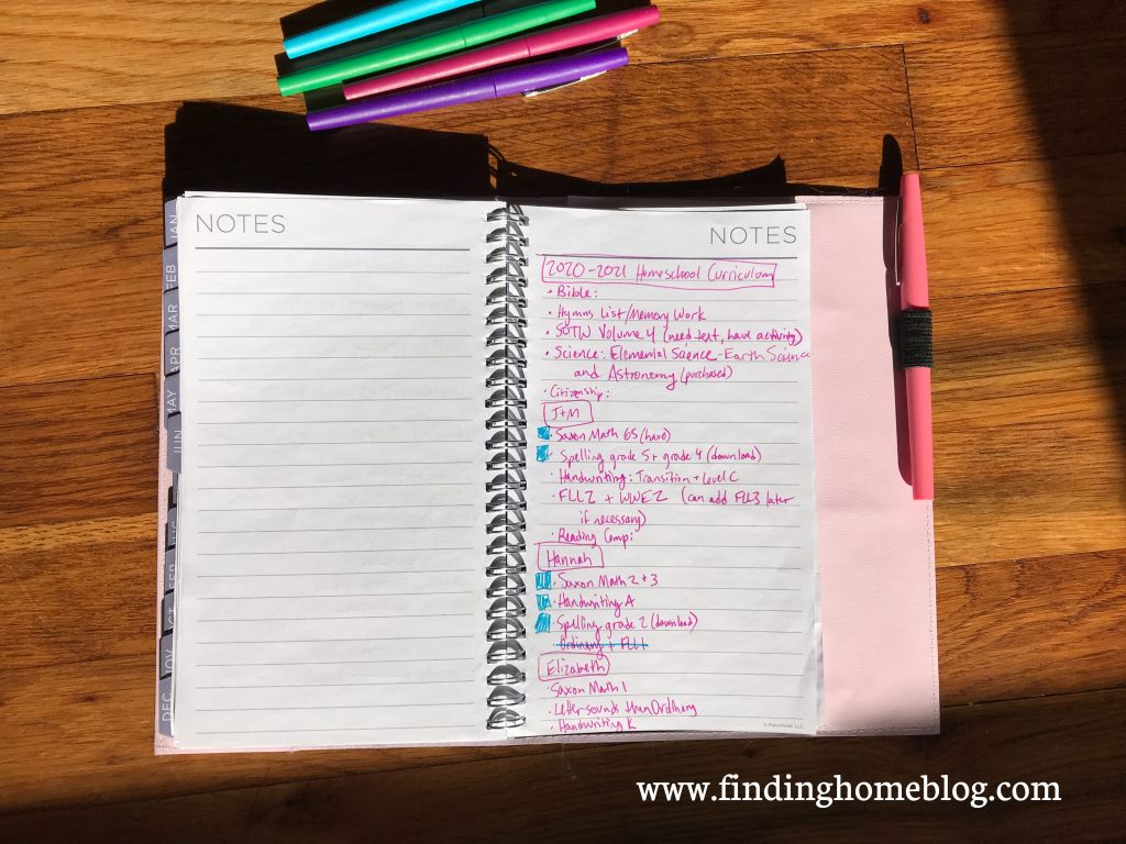 A list of homeschool subjects and curriculum choices on the right side of a planner page. Several pens nearby