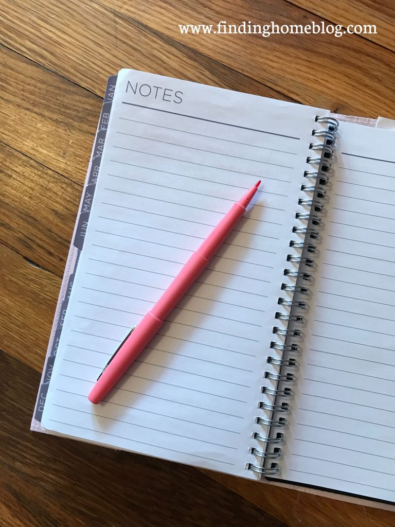 An empty planner notes page, with an open pen on top